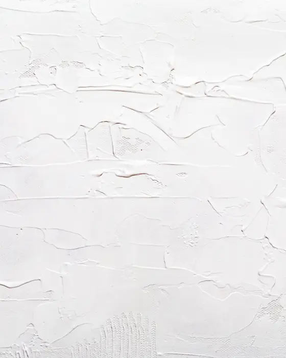 A white plastered wall with visible trowel texture before final sanding.